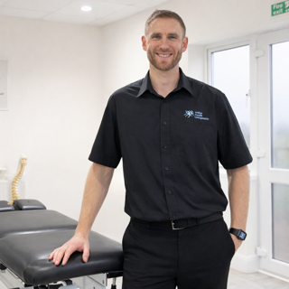 Christopher Burdon, GCC-registered chiropractor, in his treatment room at Active Health Chiropractic Clinic in Portsmouth
